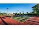 Well-maintained community tennis courts with vibrant green and red surfaces, perfect for active recreation at 19111 Vista Bay Dr # 304, Indian Shores, FL 33785