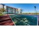 Beautifully maintained tennis courts with the condominium building in the background, perfect for recreation at 19111 Vista Bay Dr # 304, Indian Shores, FL 33785