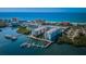 Stunning aerial view of a beachfront condo complex with boat docks and ocean views in a tropical setting at 19531 Gulf Blvd # 205, Indian Shores, FL 33785