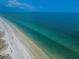 Gorgeous aerial view of the beach with pristine white sands and turquoise waters at 19531 Gulf Blvd # 205, Indian Shores, FL 33785