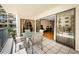 Relax on this tiled balcony with outdoor seating and sliding glass doors to the living area at 19531 Gulf Blvd # 205, Indian Shores, FL 33785