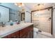 Updated bathroom featuring a glass-enclosed shower, a modern vanity, and tile floors at 19531 Gulf Blvd # 205, Indian Shores, FL 33785
