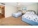 Comfortable bedroom with twin beds, carpeted floors, a ceiling fan, and ample natural light at 19531 Gulf Blvd # 205, Indian Shores, FL 33785