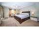Spacious main bedroom with a ceiling fan, carpeted floors, a desk, and a large window at 19531 Gulf Blvd # 205, Indian Shores, FL 33785
