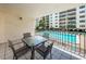 Balcony featuring outside dining space with a direct view of the community pool at 19531 Gulf Blvd # 205, Indian Shores, FL 33785