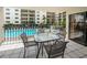 View of a patio area that overlooks the community pool, with a table and chairs for outdoor relaxation at 19531 Gulf Blvd # 205, Indian Shores, FL 33785