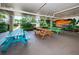 Community picnic area with multiple picnic tables, landscaping, and sunset mural at 19531 Gulf Blvd # 205, Indian Shores, FL 33785