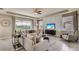 Spacious living room with stylish decor, comfortable seating, and large windows overlooking a scenic pond at 19669 Gladeview Way, Land O Lakes, FL 34638