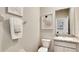Well-lit powder room featuring granite vanity, a decorative painting, and modern fixtures at 19695 Gladeview Way, Land O Lakes, FL 34638