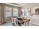 Elegant dining room with modern lighting, neutral tones, and stylish decor, perfect for Gathering dinners at 19695 Gladeview Way, Land O Lakes, FL 34638