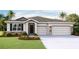Inviting single-Gathering home featuring a two-car garage, stone accents, and a well-maintained front lawn at 19695 Gladeview Way, Land O Lakes, FL 34638