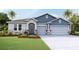 Charming single-Gathering home boasts a three-car garage, stone accents, and a beautifully landscaped front yard at 19695 Gladeview Way, Land O Lakes, FL 34638