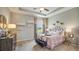 A charming bedroom features a tray ceiling, soft lighting, and tasteful decor in calming, neutral tones at 19695 Gladeview Way, Land O Lakes, FL 34638