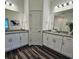 Elegant bathroom featuring dual vanities, granite counters, and modern fixtures at 2024 Sidney St, Clearwater, FL 33763