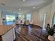 Open-concept living room and dining area with hardwood floors and plenty of natural light at 2024 Sidney St, Clearwater, FL 33763