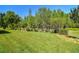 A lush green lawn stretches to the tree line in this peaceful back yard setting at 21627 Pearl Crescent Ct, Land O Lakes, FL 34637