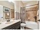 This bathroom features decorative tile and white countertops over dark cabinets at 21627 Pearl Crescent Ct, Land O Lakes, FL 34637