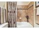 The tiled shower and tub combination bathroom include a shower curtain at 21627 Pearl Crescent Ct, Land O Lakes, FL 34637