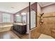 Relaxing bathroom featuring glass shower, soaking tub, and double vanity with wood look tile floors at 21627 Pearl Crescent Ct, Land O Lakes, FL 34637