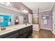 Elegant bathroom showcases a double vanity, framed shower, and serene ambiance with wood look flooring at 21627 Pearl Crescent Ct, Land O Lakes, FL 34637