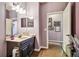 Bathroom features tile floors, artwork, vanity with sink, and a mirror at 21627 Pearl Crescent Ct, Land O Lakes, FL 34637