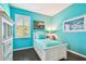 Bright bedroom features light blue walls, wood flooring, and a window with white shutters at 21627 Pearl Crescent Ct, Land O Lakes, FL 34637