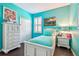 This adorable bedroom features a window with white shutters, an adjacent closet, and wood floors at 21627 Pearl Crescent Ct, Land O Lakes, FL 34637