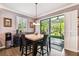 Inviting dining area featuring a marble-top table and seamless access to the outdoor patio through sliding glass doors at 21627 Pearl Crescent Ct, Land O Lakes, FL 34637