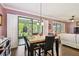 Dining area with a table and chairs, large sliding glass doors, and views into the living room at 21627 Pearl Crescent Ct, Land O Lakes, FL 34637