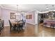 Open floor plan with a dining area featuring wood-look tile flooring and views into the kitchen at 21627 Pearl Crescent Ct, Land O Lakes, FL 34637