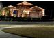 Charming home with manicured landscaping and decorative outdoor lighting at night at 21627 Pearl Crescent Ct, Land O Lakes, FL 34637