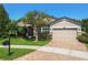 Beautiful home with manicured landscaping, brick paver driveway, and a well-maintained lawn at 21627 Pearl Crescent Ct, Land O Lakes, FL 34637