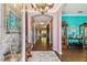 Elegant foyer with hardwood floors, decorative chandelier, and arched doorways at 21627 Pearl Crescent Ct, Land O Lakes, FL 34637