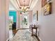 Grand foyer features a beautiful chandelier, tile flooring and ample natural light at 21627 Pearl Crescent Ct, Land O Lakes, FL 34637