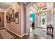 Elegant foyer showcases a wall with Gathering photos, tile flooring, and a grand chandelier at 21627 Pearl Crescent Ct, Land O Lakes, FL 34637