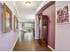 Hallway features tile floors, art on the wall, and an antique grandfather clock at 21627 Pearl Crescent Ct, Land O Lakes, FL 34637