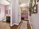Hallway leading to bathroom features tile floors, art on the walls and entryways at 21627 Pearl Crescent Ct, Land O Lakes, FL 34637