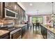 This kitchen features dark cabinets, stainless appliances, and an adjacent dining area at 21627 Pearl Crescent Ct, Land O Lakes, FL 34637