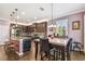 Open concept kitchen showcases stainless steel appliances, dark wood cabinets, and a cozy eat-in dining area at 21627 Pearl Crescent Ct, Land O Lakes, FL 34637