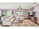 Cozy living room boasts natural light, neutral tones, and seamless transition to the outdoor patio at 21627 Pearl Crescent Ct, Land O Lakes, FL 34637