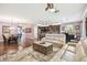 Open-concept living area showcases kitchen, dining, and living spaces, with wood floors and modern decor at 21627 Pearl Crescent Ct, Land O Lakes, FL 34637