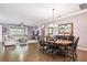 Open floor plan featuring a living room and dining area with tile flooring, stylish furnishings, and natural light at 21627 Pearl Crescent Ct, Land O Lakes, FL 34637