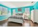 Bright main bedroom featuring vibrant turquoise walls, plantation shutters, and elegant white furniture at 21627 Pearl Crescent Ct, Land O Lakes, FL 34637