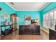 Bright home office with blue walls, a large desk, and tile floors at 21627 Pearl Crescent Ct, Land O Lakes, FL 34637