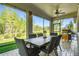 Inviting screened-in patio with outdoor dining and grilling area overlooking the serene green backyard at 21627 Pearl Crescent Ct, Land O Lakes, FL 34637