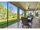 Relax on the screened-in patio, complete with dining area and grill overlooking the beautiful landscaped yard at 21627 Pearl Crescent Ct, Land O Lakes, FL 34637