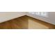 The room features new wood flooring and a window with white shutters at 21627 Pearl Crescent Ct, Land O Lakes, FL 34637