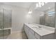 Modern bathroom with double vanity, quartz countertop and tiled shower at 2731 Winding Creek Trl, North Port, FL 34289