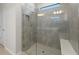 Large tiled walk-in shower features glass door and built in bench at 2731 Winding Creek Trl, North Port, FL 34289