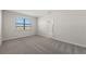 Bright bedroom with plush carpeting and natural light from a window at 2731 Winding Creek Trl, North Port, FL 34289